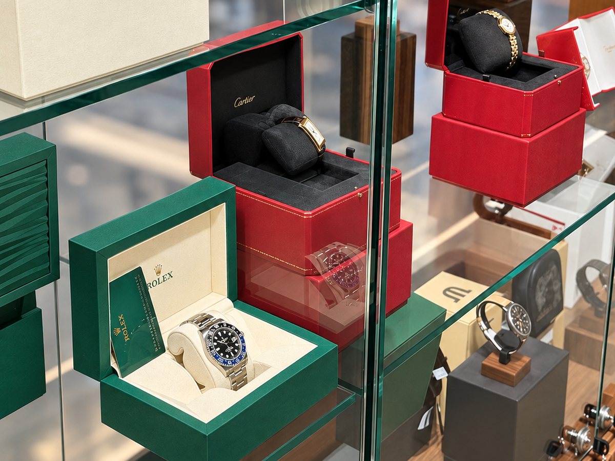 Watches shown in their original boxes, with their papers