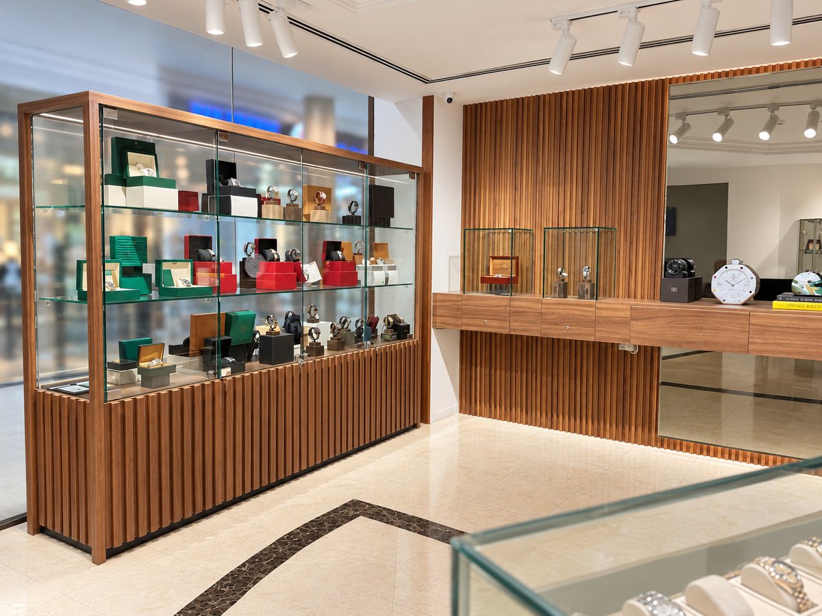 The showroom: the walnut display cabinet and the wall cases